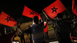 Moroccans from a human rights association hold Moroccan flags during a protest in the border area which separates Spain from Morocco in Nador