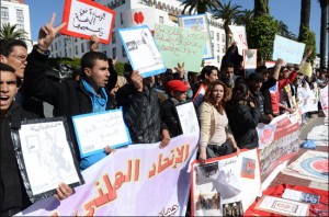 Young demonstrators hold placards and shout slogans during a protest calling for economic and social reforms in Rabat on March 23, 2014 [AFP/Fadel Senna] 