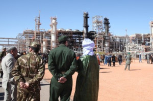 In this file photo, Algerian soldiers and officials stand in front of the In Amenas gas plant that former Algerian soldier Mokhtar Belmokhtar’s militants assaulted in 2013. (Associated Press)